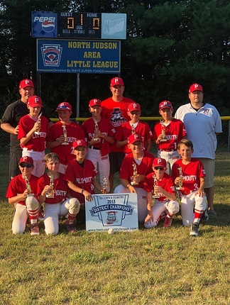 Nick Chaney with his team after winning the 12U District championship in 2018.